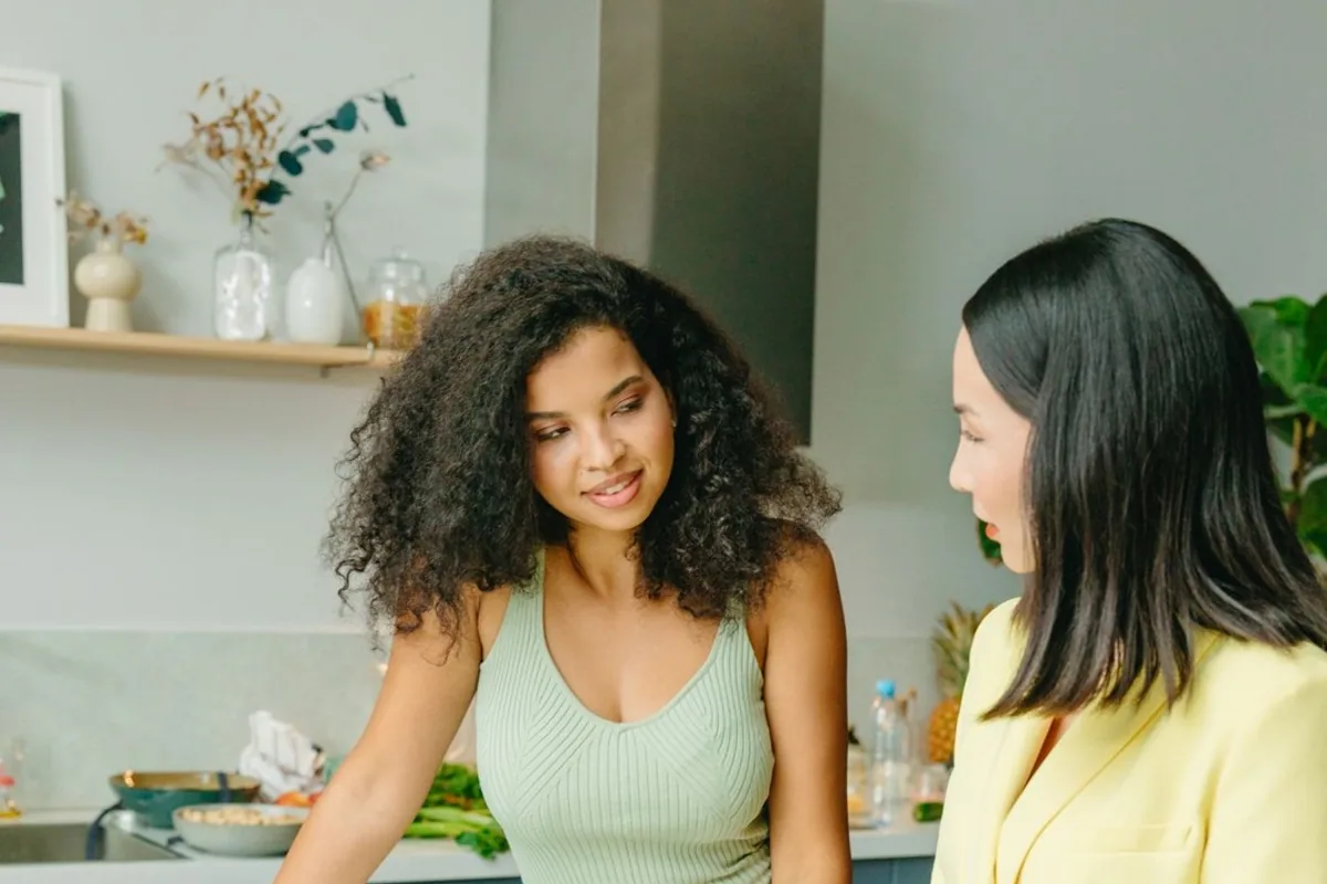 Two women discussing food and nutrition at a table.