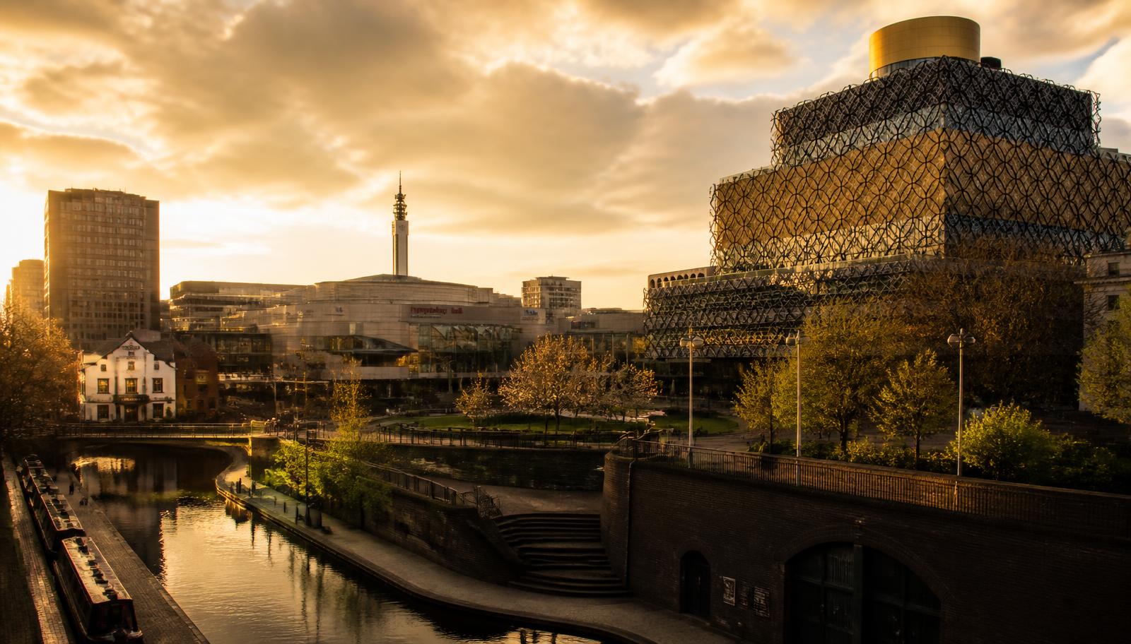 Birmingham city skyline at golden hour with canal and Library of Birmingham